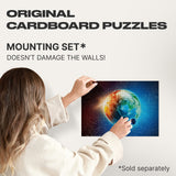 Earth 1000 pieces wooden map puzzle — hand holding wooden puzzle piece detail