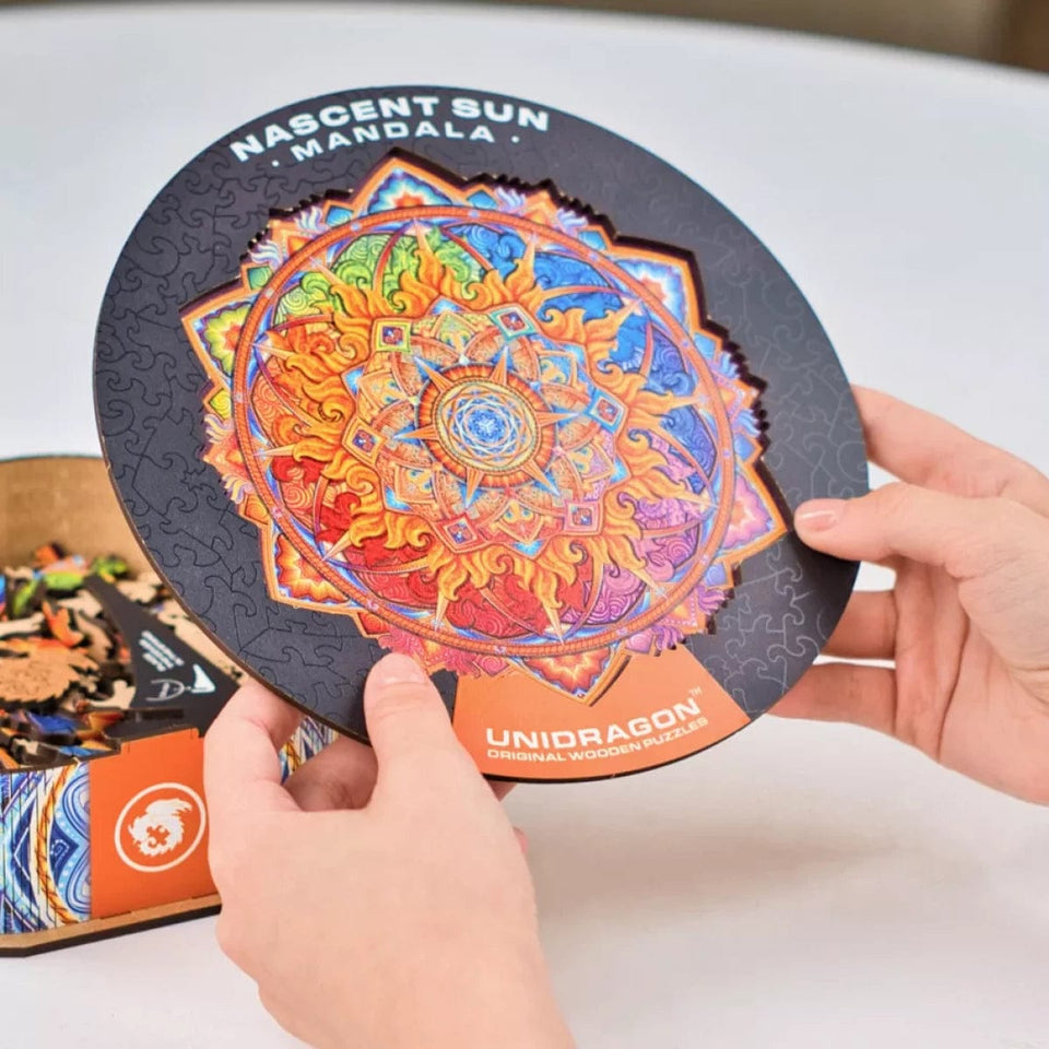 Mandala Nascent Sun mandala wooden puzzle — in use with hands assembling