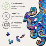 Magnetic Octopus wooden jigsaw puzzle with deep-sea artwork — hand holding wooden puzzle piece showing detail