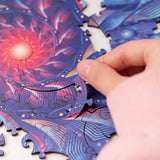 Depth of Field wooden brain teaser puzzle — in use with hands assembling
