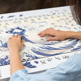 The Great Wave off Kanagawa wooden puzzle — in use with hands assembling