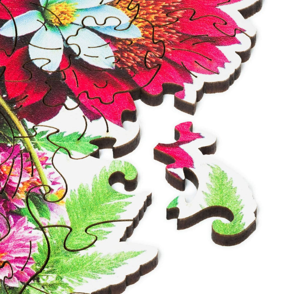 Blooming Bouquet wooden puzzle — hand holding wooden puzzle piece detail