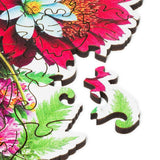 Blooming Bouquet wooden puzzle — hand holding wooden puzzle piece detail