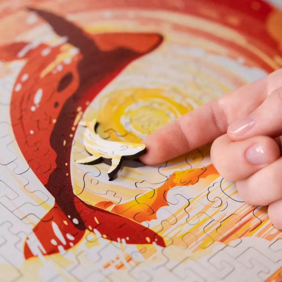 Solar Whale wooden brain teaser puzzle — in use with hands assembling