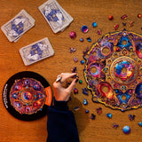 Mandala Space Dreams mandala wooden puzzle — in use with hands assembling
