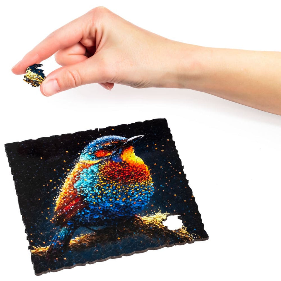 Birdy Jigsaw Puzzle wooden puzzle — hand holding wooden puzzle piece detail