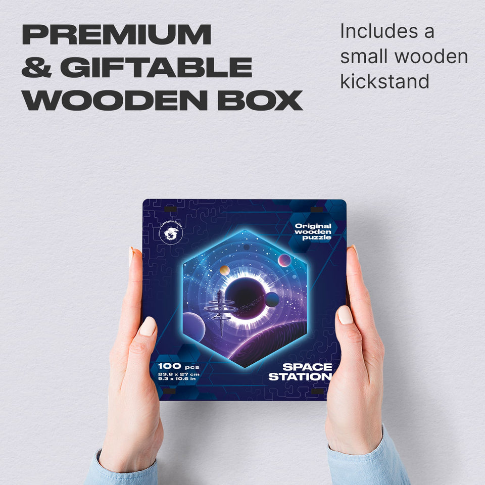 Space Station wooden brain teaser puzzle — hand holding wooden puzzle piece detail