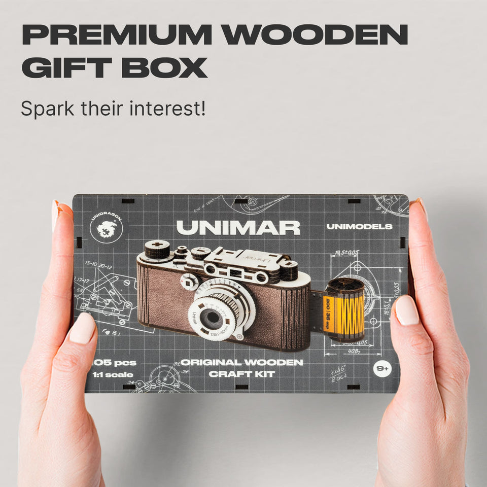 Camera Unimar wooden puzzle — hand holding wooden puzzle piece detail