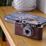 Camera Unimar wooden puzzle — in use with hands assembling