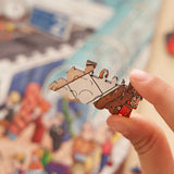 Station City wooden art puzzle — in use with hands assembling