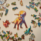 Triceratops wooden dinosaur puzzle for kids — hand holding wooden puzzle piece detail
