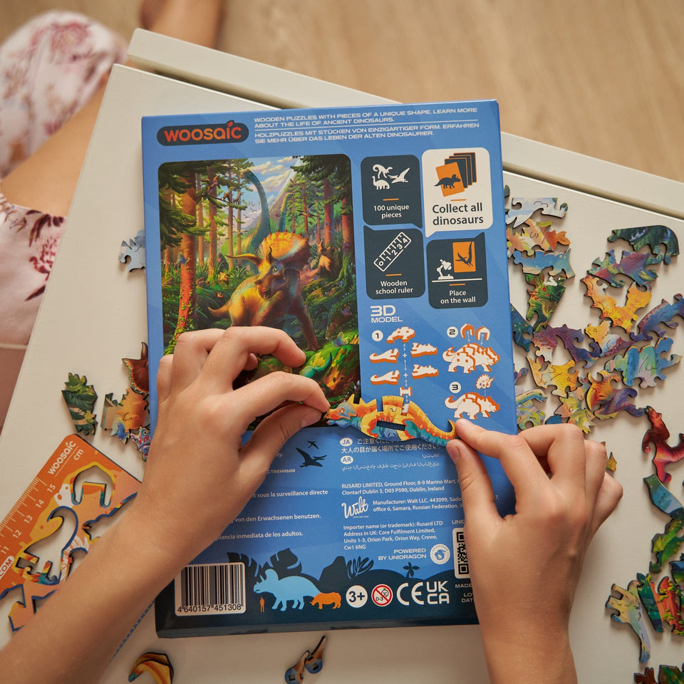 Triceratops wooden dinosaur puzzle for kids — in use with hands assembling