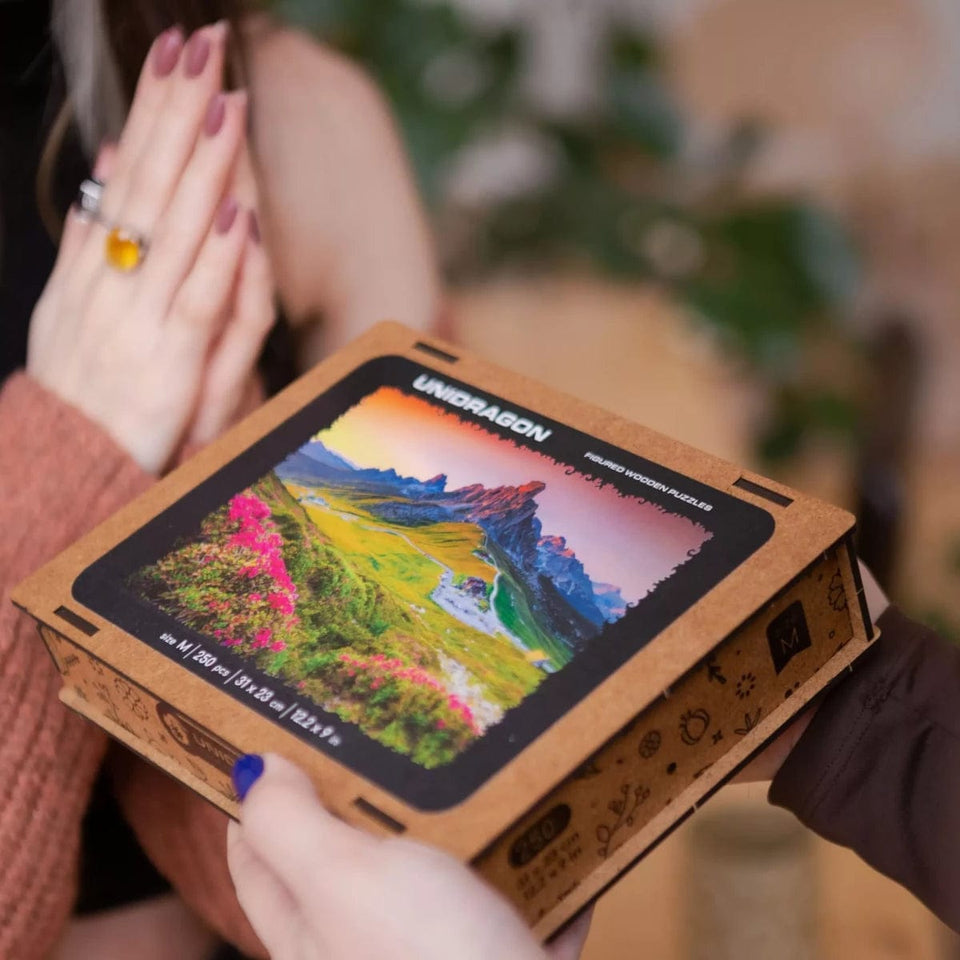 Mountain wooden travel puzzle — in use with hands assembling