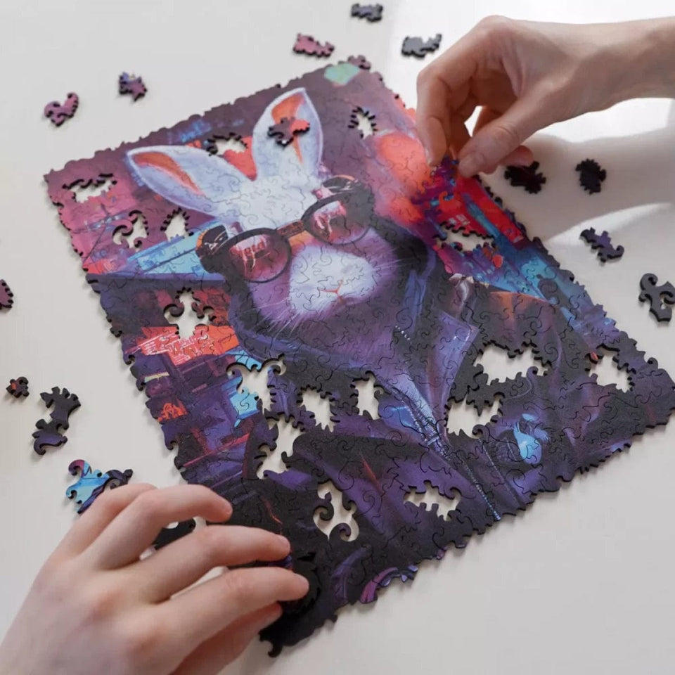 Cyber Rabbit wooden animal puzzle — in use with hands assembling