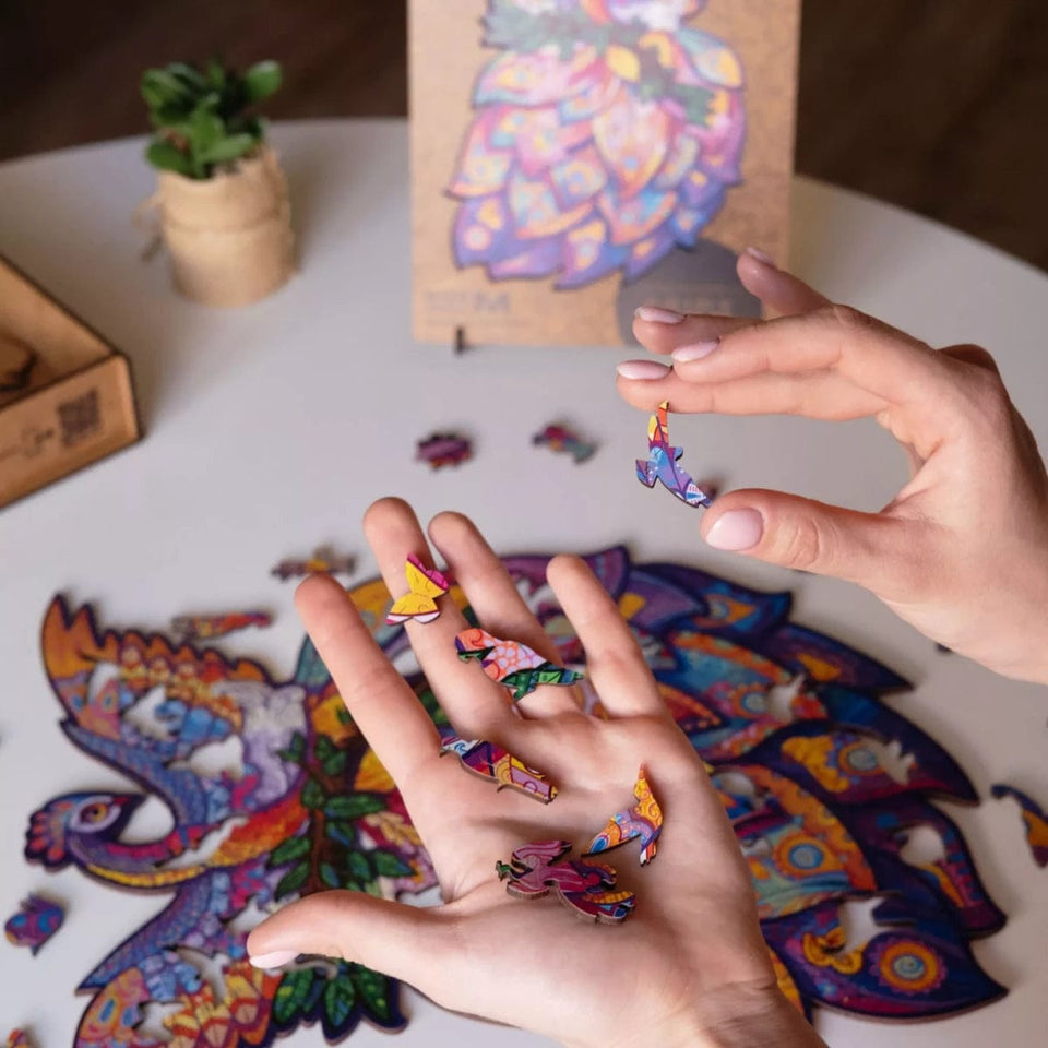 Fairy Bird wooden animal puzzle — in use with hands assembling