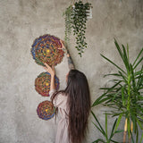 Mandala Inexhaustible Abundance mandala wooden puzzle — in use with hands assembling