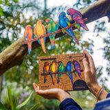 Playful Parrots 5 in 1 wooden puzzle — in use with hands assembling