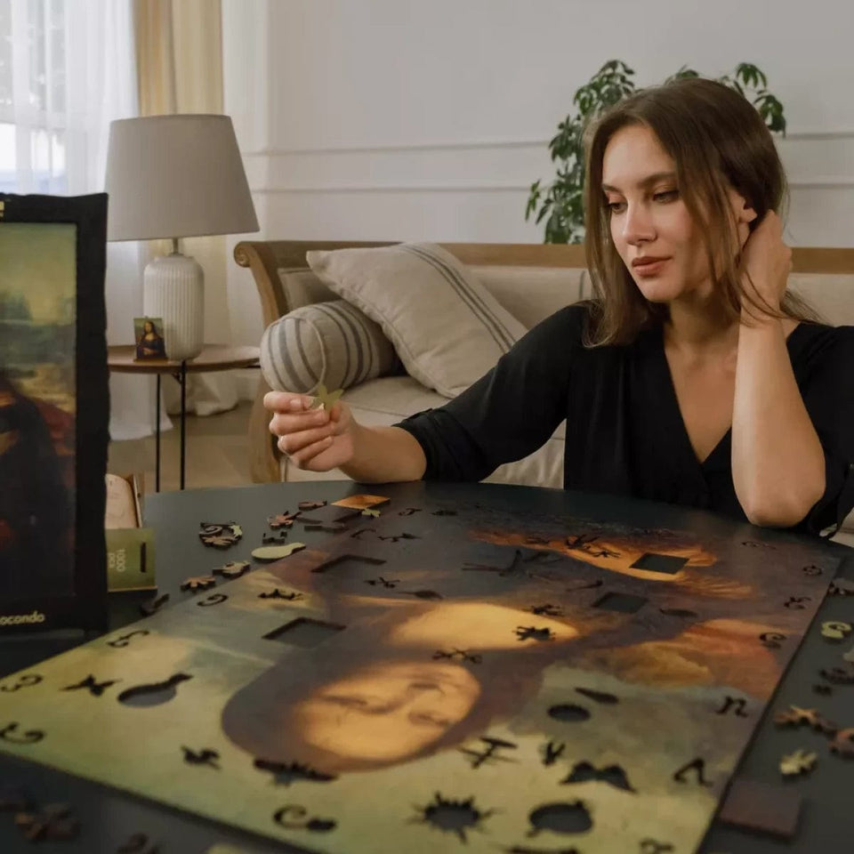 Mona Lisa wooden art puzzle — in use with hands assembling