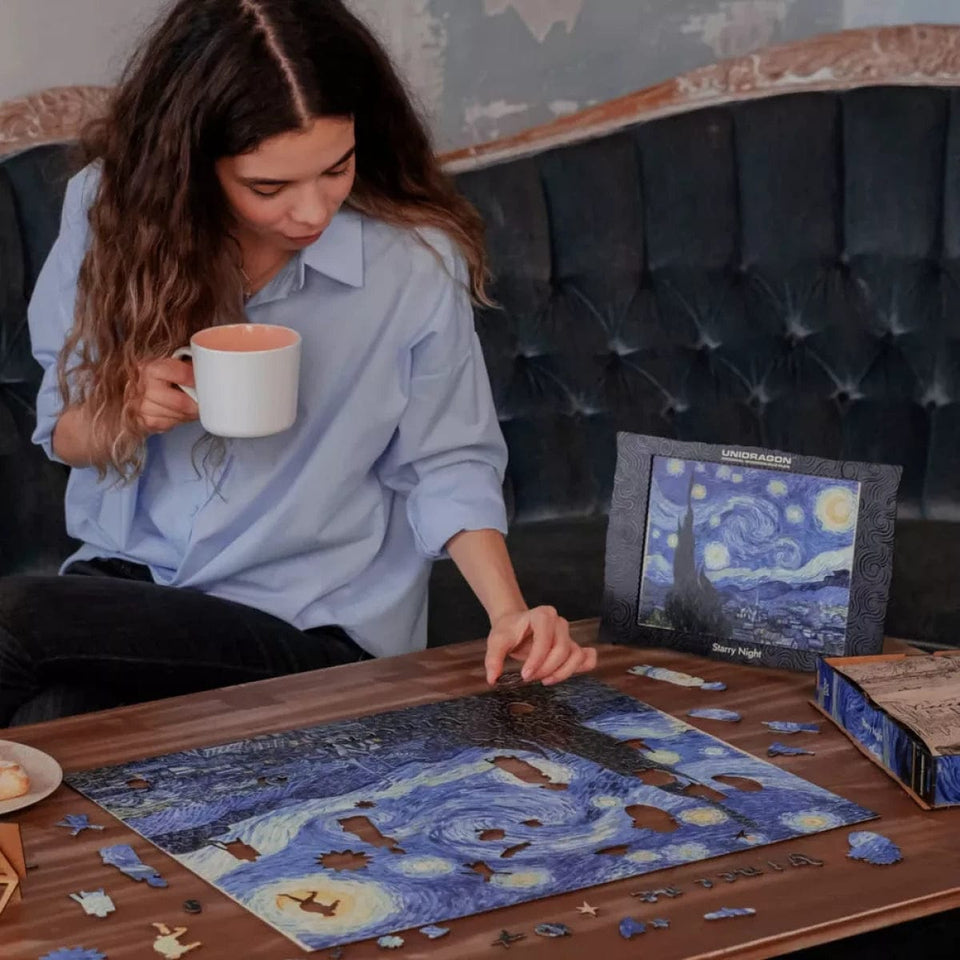 Starry Night wooden art puzzle — in use with hands assembling