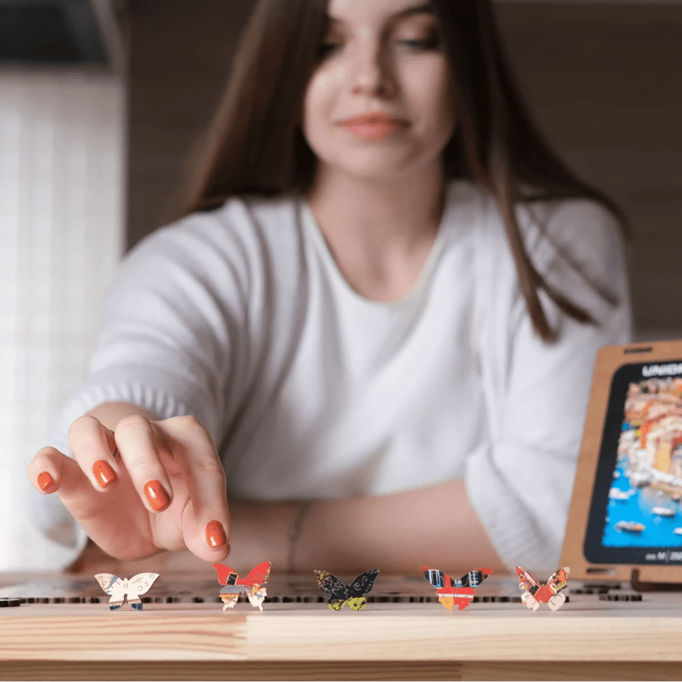 WOOSAIC Italian Riviera Limited Edition wooden travel puzzle — in use with hands assembling