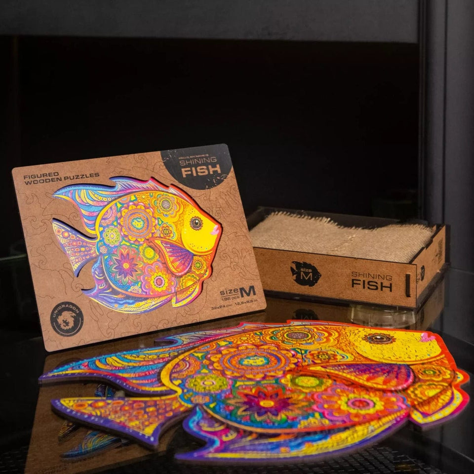 Shining fish wooden puzzle — in use with hands assembling