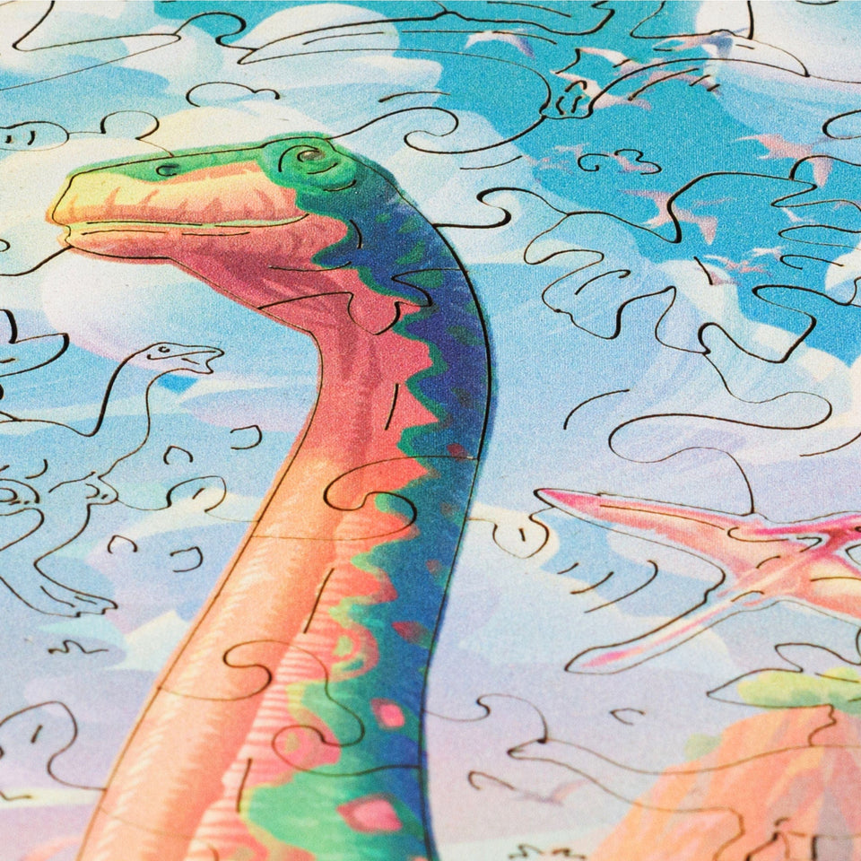 Diplodocus wooden dinosaur puzzle for kids — hand holding wooden puzzle piece detail